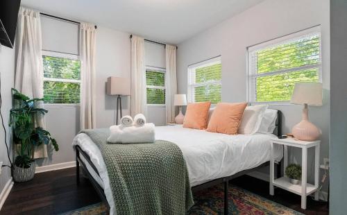 a bedroom with a bed and two windows at *Super close to Hospitals|UAB|Open fl plan|2 bdr in Birmingham