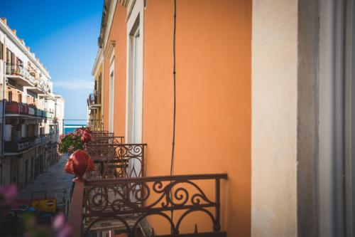a balcony of a building with a fence and flowers at B&B Le Ferule in Manfredonia