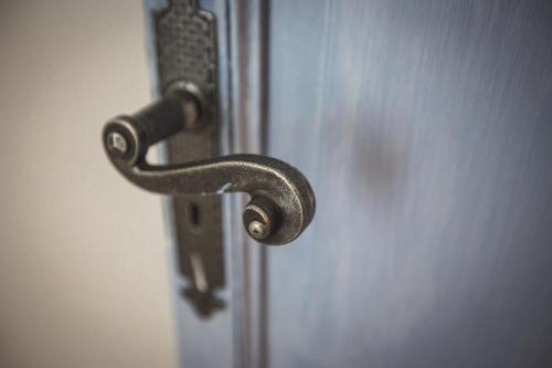 a metal door handle on a white door at B&B Le Ferule in Manfredonia