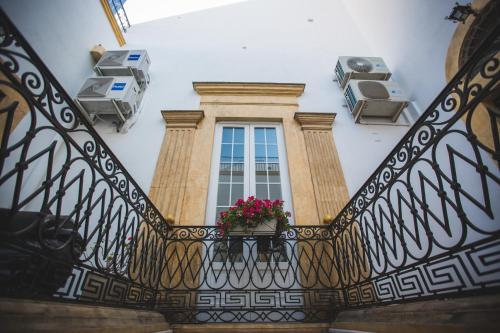 a window with a flower pot on a balcony at B&B Le Ferule in Manfredonia