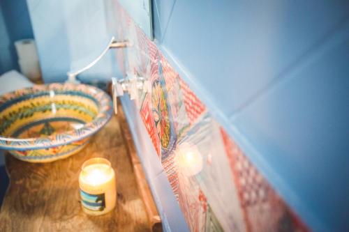a bathroom with a candle and a counter with a sink at B&B Le Ferule in Manfredonia