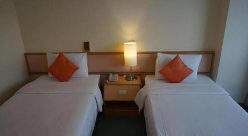 Voodi või voodid majutusasutuse The Majestic Sakon Nakhon Hotel toas