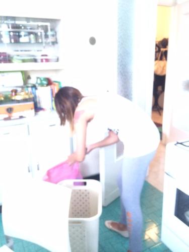 a girl sitting on a chair in a kitchen at La Terrazza Sul Po in Turin