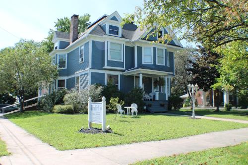 a blue house with a sign in front of it at The White Birch Inn in Berwick