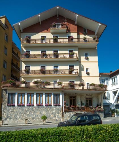 a building with balconies and a car parked in front of it at Miramonti in Calizzano