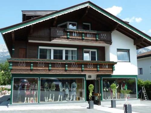 a building with a lot of windows in front of it at Alpking Hostel in Ellmau