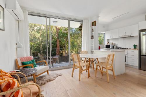 a kitchen and dining room with a table and chairs at Lovely Harbourside 1-Bed Close To Sydney Landmarks in Sydney
