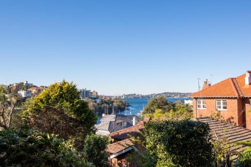a view of a city with a river and houses at Lovely Harbourside 1-Bed Close To Sydney Landmarks in Sydney
