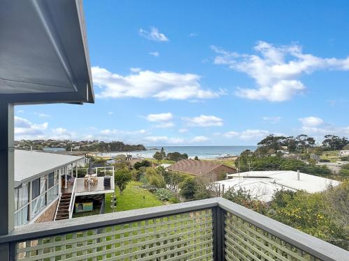 a view of the ocean from the balcony of a house at 2-Bed Beach Haven with Garden & Alfresco Dining in Malua Bay