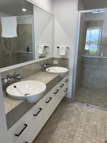 a bathroom with two sinks and a shower at Bluewater Haven in Buddina