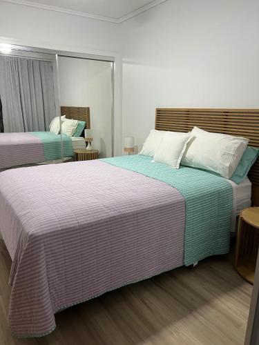 a bedroom with two beds and a mirror at Bluewater Haven in Buddina