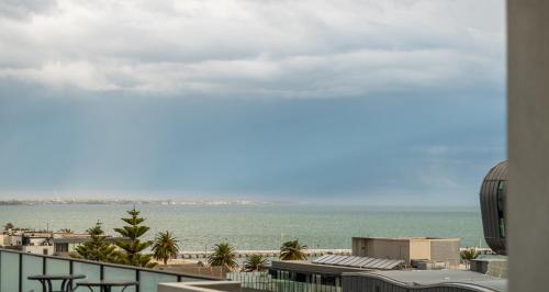 a view of the ocean from the balcony of a building at "Nott's Nook"- 1-Bed with Rooftop Views in Melbourne