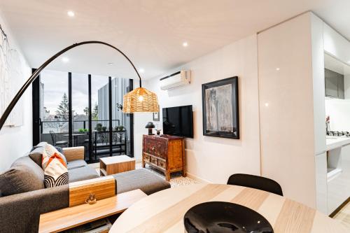 a living room with a couch and a table at "Nott's Nook"- 1-Bed with Rooftop Views in Melbourne