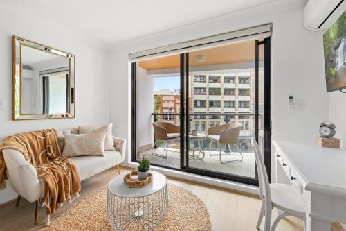 a living room with a couch and a table at Ideal Studio Inner-City Pad with Private Balcony in Sydney