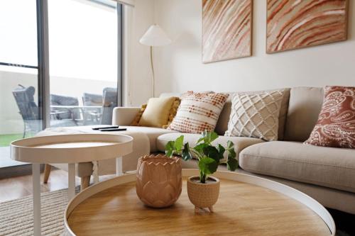 a living room with a couch and a table at Ground Level 1-Bed: Courtyard & Alfresco Dining in Weston Creek