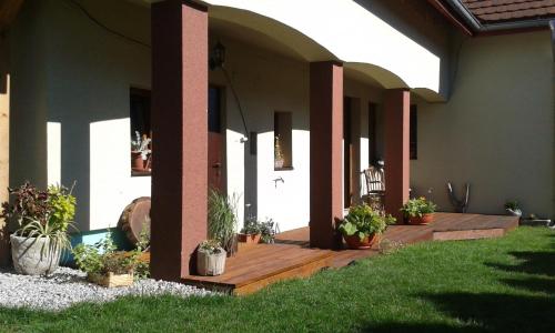 a porch of a house with potted plants on it at Apartmány MarAqua in Liptovský Trnovec