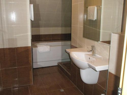 a small bathroom with a sink and a shower at BLOCK 531 ApartHouse BLOCK 533 in Sofia