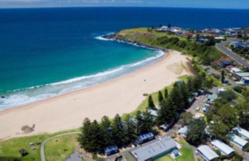 an aerial view of a beach and the ocean at Lovely 3-Bed with Alfresco Dining by Attractions in Kiama