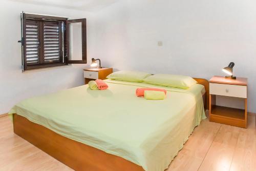 a bedroom with a bed with two pillows on it at Ante Apartments in Trstenik