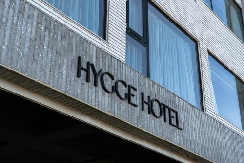 a close up of the magee hotel sign on a building at Hygge Hotel in Seogwipo