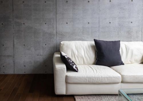 a white couch with two pillows on it in a room at Full Circle Apartments in Kutchan