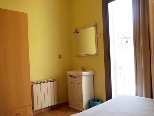 a bathroom with a sink and a mirror at Hostal Delfos in Barcelona