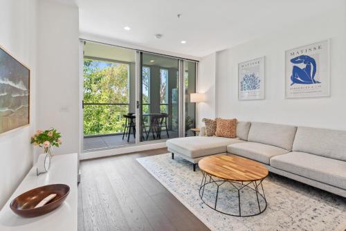 a living room with a couch and a table at Chic 2-Bed with Free Parking in South Yarra in Melbourne