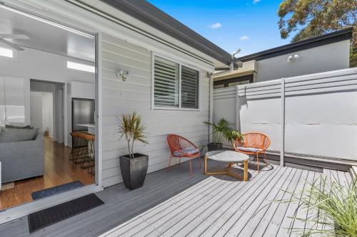 a patio with two chairs and a table on a deck at Relaxing 2-Bed Home Close to Beaches and Parks in Sydney
