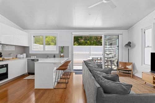 a kitchen and living room with a couch and a table at Relaxing 2-Bed Home Close to Beaches and Parks in Sydney