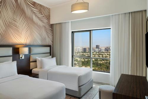 Ένα ή περισσότερα κρεβάτια σε δωμάτιο στο Vintage Grand Hotel Apartments Dubai