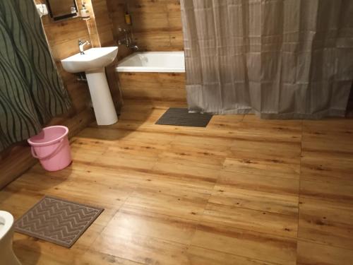 a bathroom with a toilet and a sink and a tub at Bamaeri Royal Resort in Nongpoh
