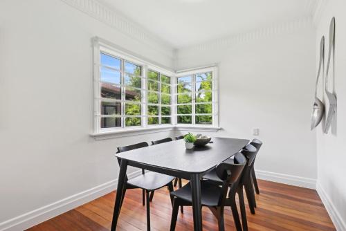 a dining room with a table and chairs and a window at Spacious 3-Bed Home in Morningside with Backyard in Brisbane