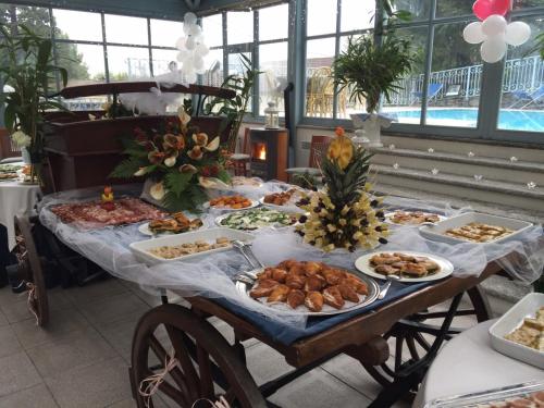 a table full of food on a table at Hotel Lario in Mezzegra