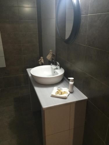 a bathroom with a sink and a mirror at Villa Livadaros in Karterados