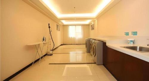 a kitchen with a sink and a washing machine at City Comfort Inn Shenzhen Longhua Bus Station Qinghu Metro Station in Tiantangwei