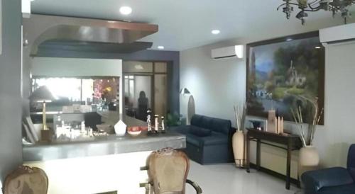 a living room with blue furniture and a large mirror at Castle Dreams Hotel in Daliao