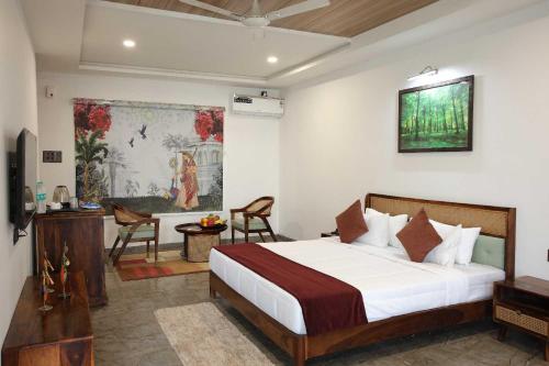 Ένα ή περισσότερα κρεβάτια σε δωμάτιο στο Sai Dhara Resort