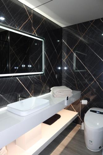 a bathroom with a sink and a toilet at Galactic getaways JUPITER in Prestatyn