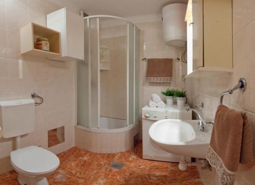 a bathroom with a shower and a toilet and a sink at Bačvice beach apartment in Split