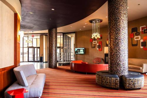 a lobby with a couch and a chair and a table at Radisson Hotel Duluth-Harborview in Duluth