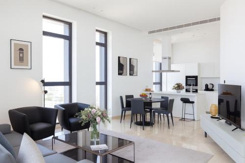 a living room with a couch and a table at SkyHigh Park View Residence in Nicosia