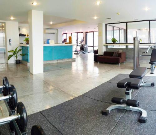 a gym with dumbbells in the middle of a room at The Lantern Resorts Patong - SHA Extra Plus in Patong Beach
