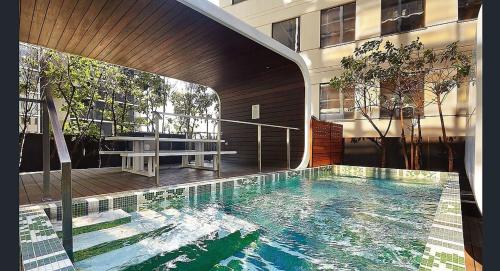 a swimming pool in the middle of a building at Chic City Escape with Pool, Gym & Parking in Melbourne