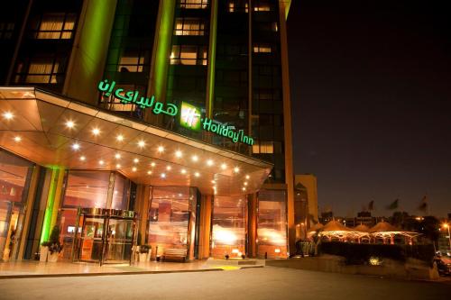 a building with lights on top of it at night at Holiday Inn Citystars by IHG in Cairo