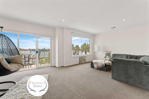 a living room with a couch and a table at Amazing Lake View family-friendly Holiday Home in Cheltenham