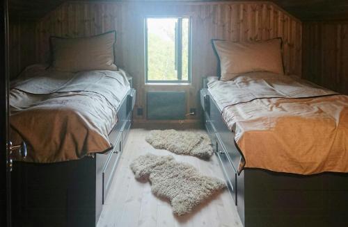 two twin beds in a room with a window at Mountain Cabin With Panoramic Views In Oppdal in Gorset