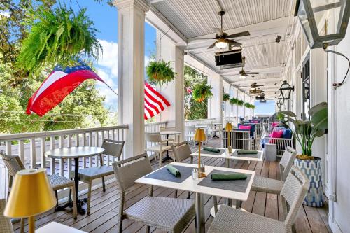 a restaurant with tables and chairs on a porch at The Partridge Inn Augusta, Curio Collection by Hilton in Augusta