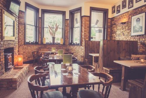 a dining room with tables and chairs and windows at The Royal Norfolk Hotel in Folkestone
