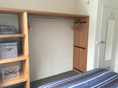 a bedroom with a bunk bed with a wooden door at Ripparoo Lodge in Falls Creek