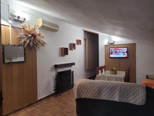 a living room with a couch and a fire place at Casa de la Luz in Cuevas del Campo